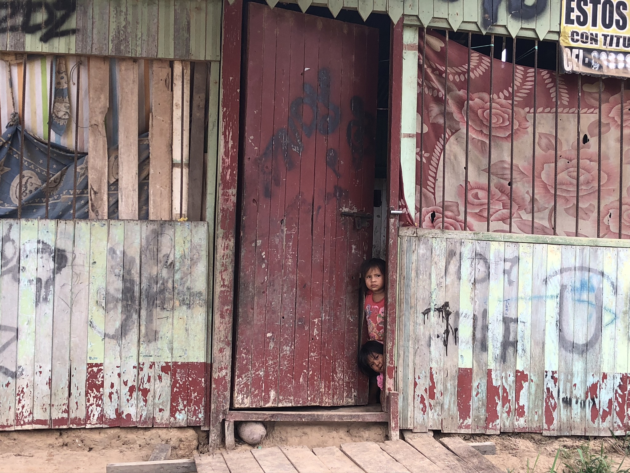 Haven of Hope Intl. Nation of Orphans, Small Child in Peru looking out a door