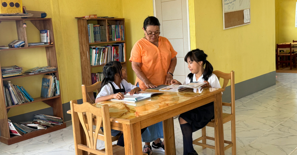 Peru girls teacher schoolwork 1200x628