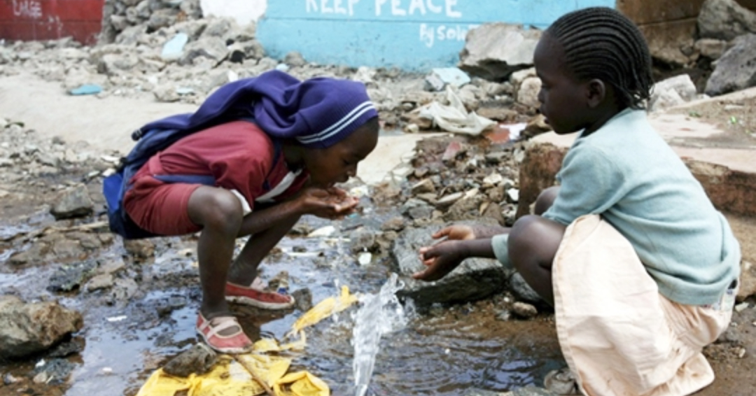 Children on street in Africa drinking dirty water - orphans