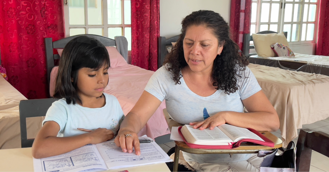 Tia Esther helping Yandi with homework 1088x566