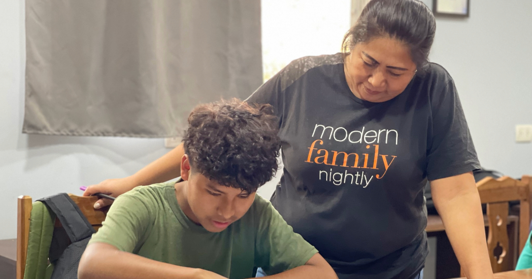 Tia Magda supervising homework with Javier 1080s566